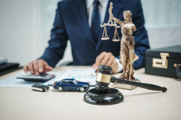 Attorney at desk with gavel, scales of justice, and auto accident documentation