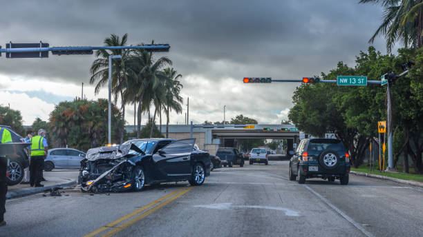 Severely damaged vehicle at a major intersection collision scene